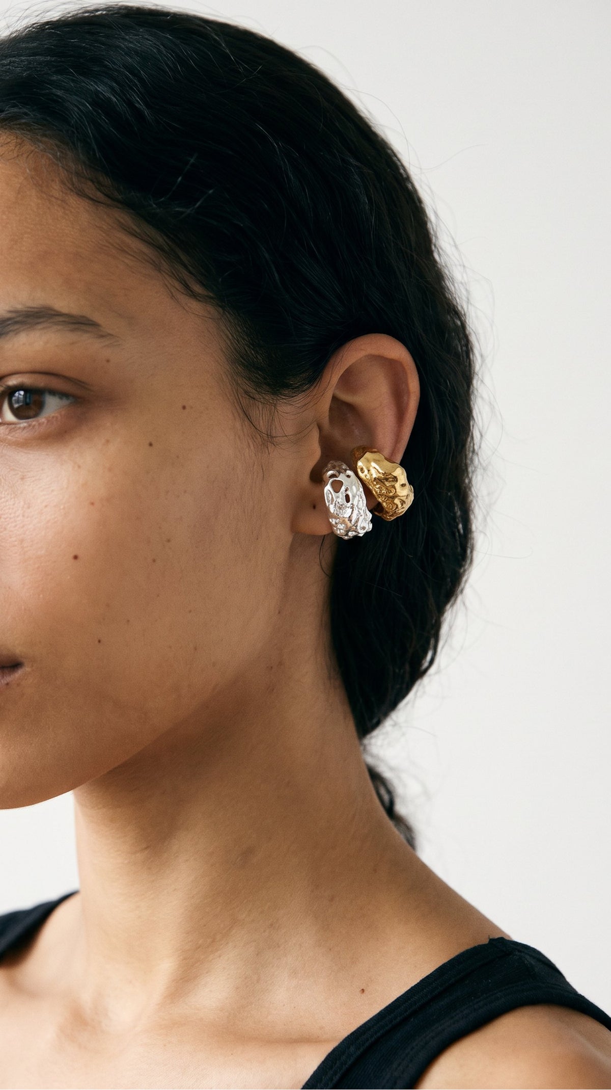 Model wearing Apreels ear cuffs in silver and gold